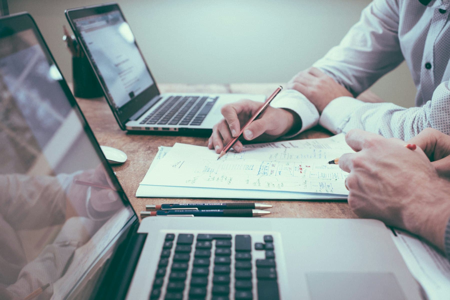 Two people reviewing shipment paperwork together at a desk