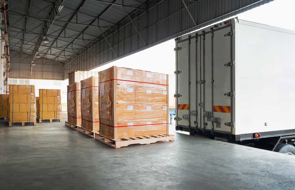 Palletized cartons and totes staged for consolidation in a warehouse