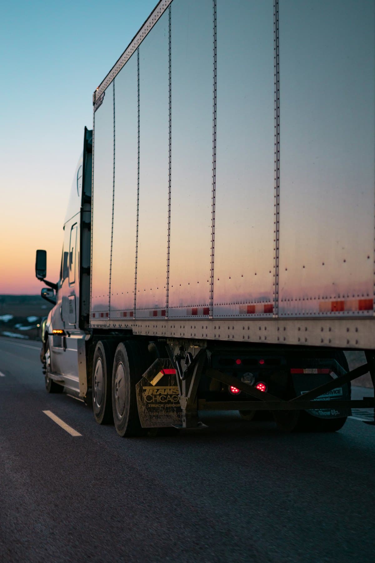 A 53-foot dry van trailer on the highway at dusk
