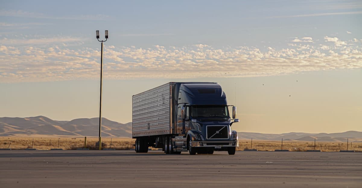 A dry van tractor-trailer running an open highway