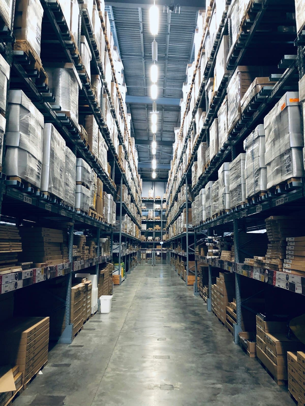 Racked pallets lining a warehouse aisle, staged for onward movement