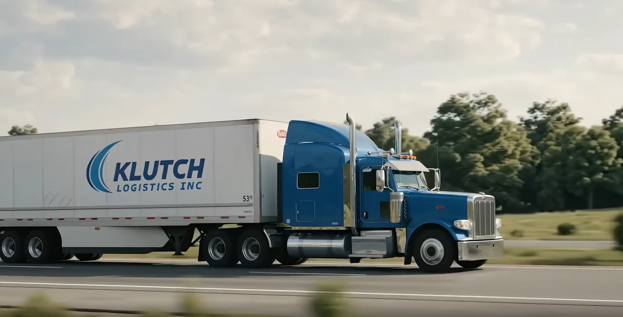 A Klutch Logistics tractor-trailer running a highway lane